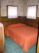 The first bedroom in Cabin #4 has a double bed.