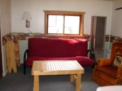 The livingroom in Cabin #13 has a twin bed for extra sleeping capacity or for just lounging around.