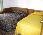 The master bedroom in Cabin #14 has two double beds.