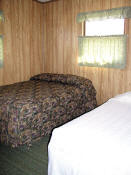 The second bedroom in Cabin #9 has a double bed and a twin bed.